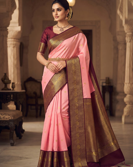 Baby pink Kanchipuram pure silk saree with gold butta motifs and a maroon border featuring intricate gold peacock weaving.