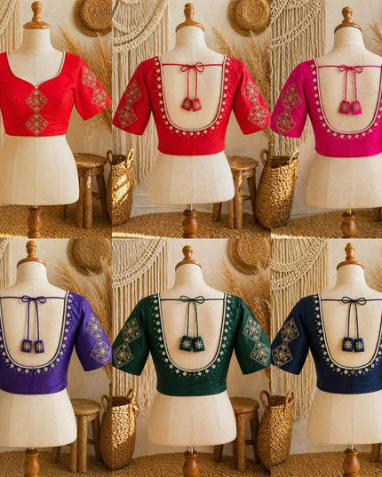 Six blouse options displayed on mannequins in a 2x3 grid, each with a different base color: red, pink, purple, green, and navy. The blouses have a deep V-neckline, short sleeves, and ornate gold embroidery around the neckline and sleeves, with a tie detail at the center back.